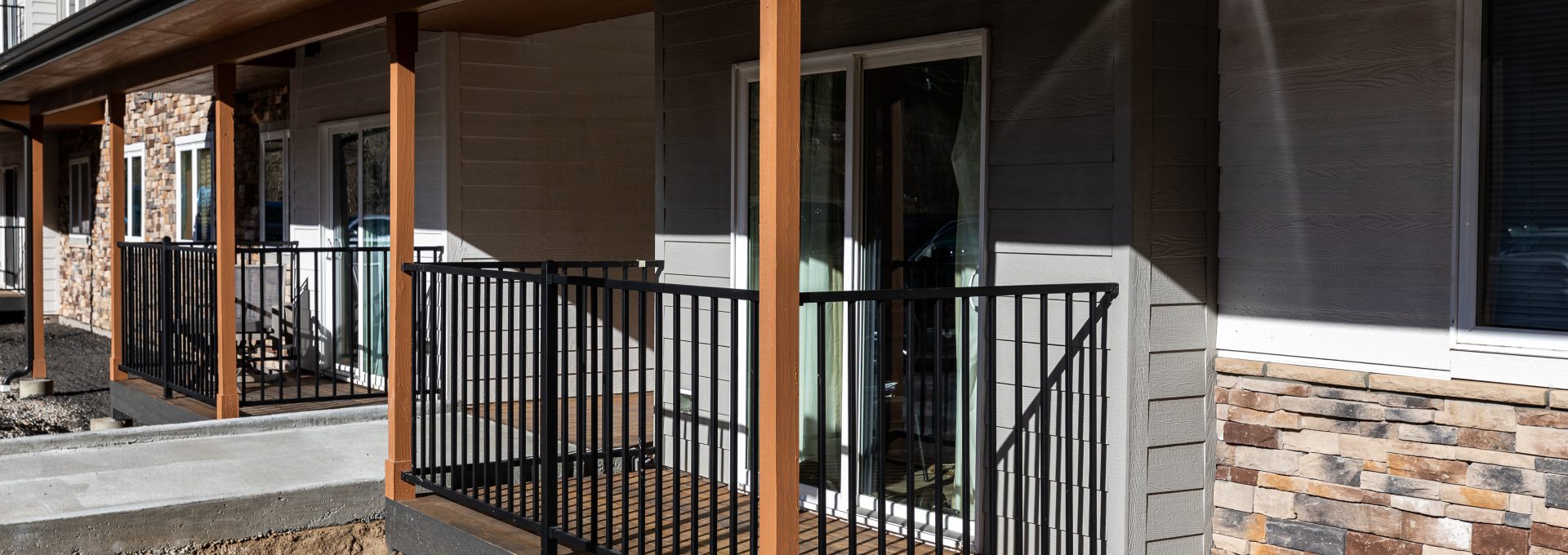 the front of a building with a balcony and railing at The Bighorn Crossing