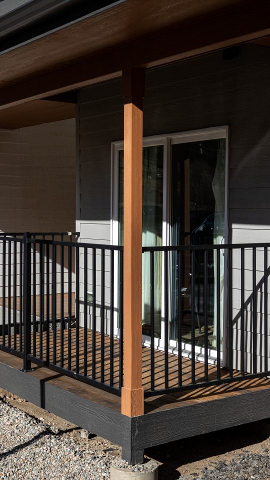 the front of a building with a balcony and railing at The Bighorn Crossing