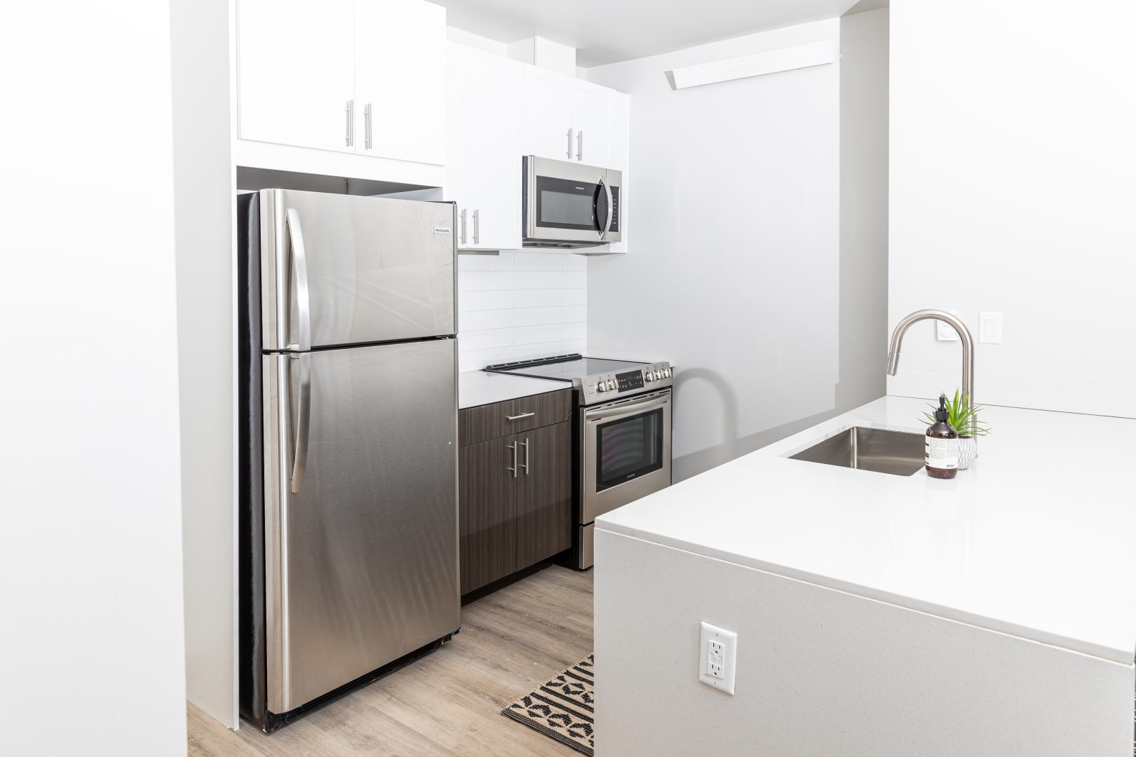 a kitchen with stainless steel appliances and a white counter at The Bighorn Crossing