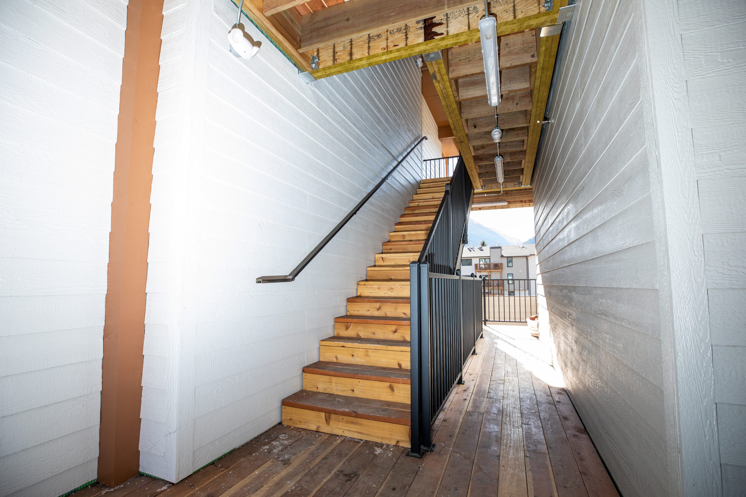 a stairway leading to a lofted area with wooden floors at The Bighorn Crossing