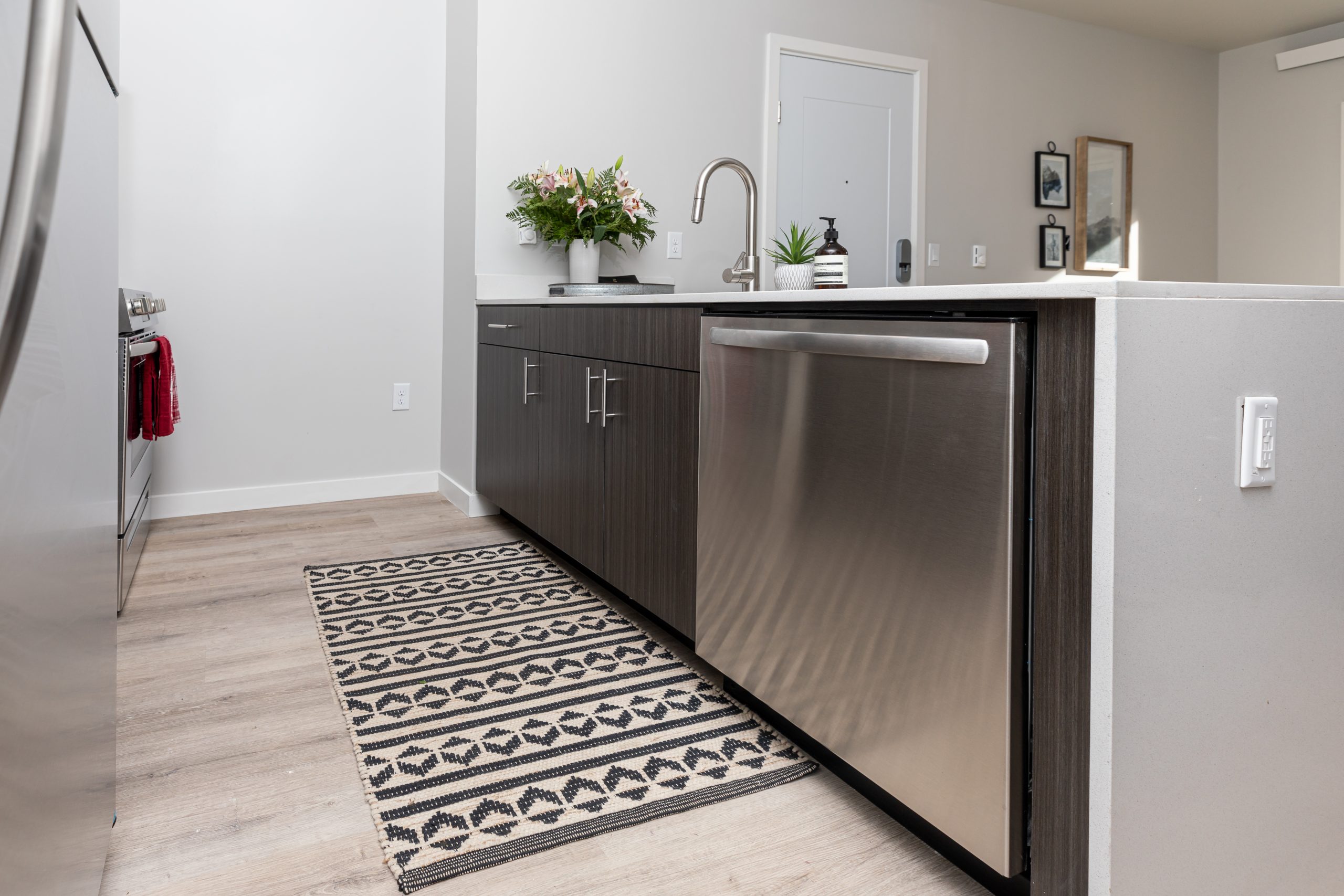 a kitchen with stainless steel appliances and a rug at The Bighorn Crossing