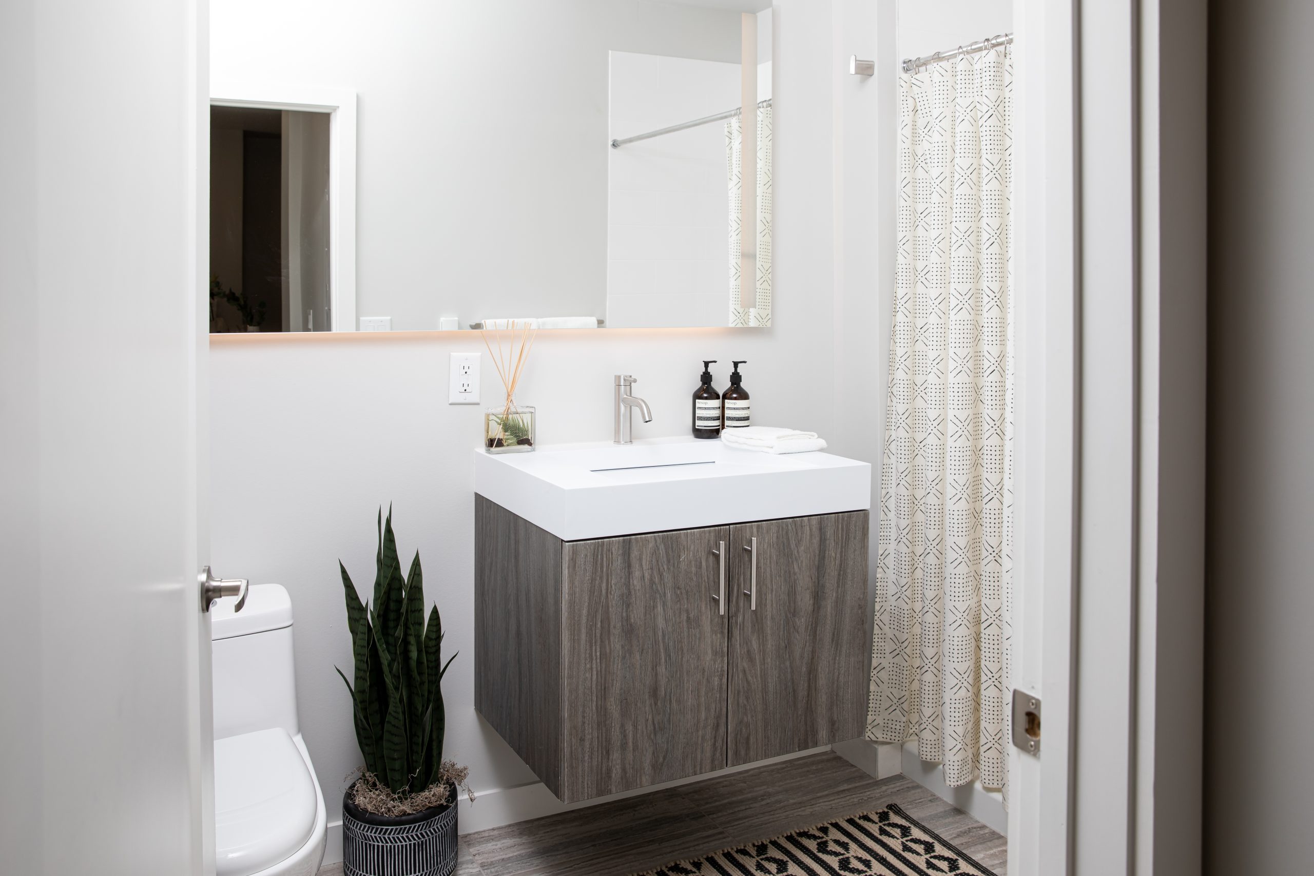 a bathroom with a white vanity and a wooden cabinet at The Bighorn Crossing