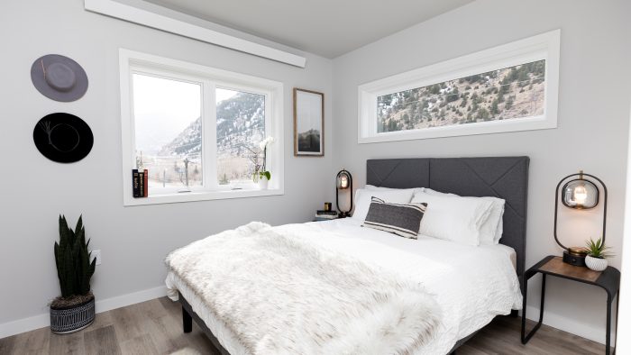 a bedroom with a white bed and a window at The Bighorn Crossing