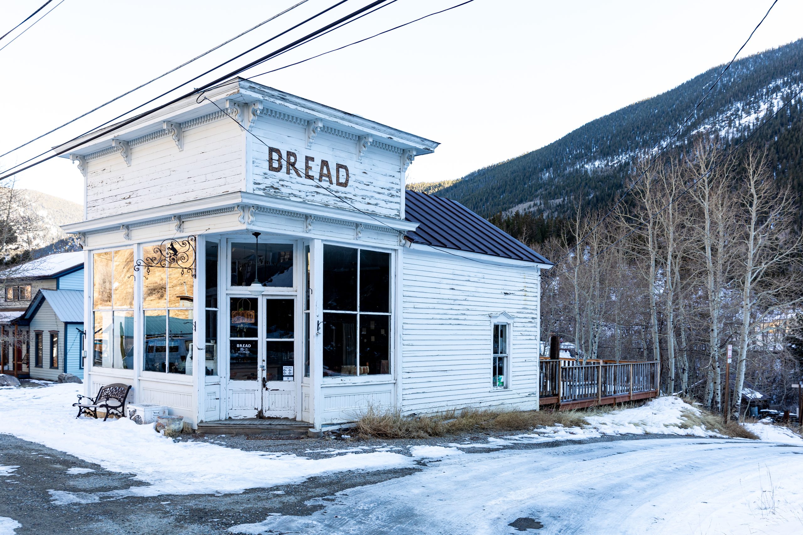 a white building with a sign that says bread at The Bighorn Crossing