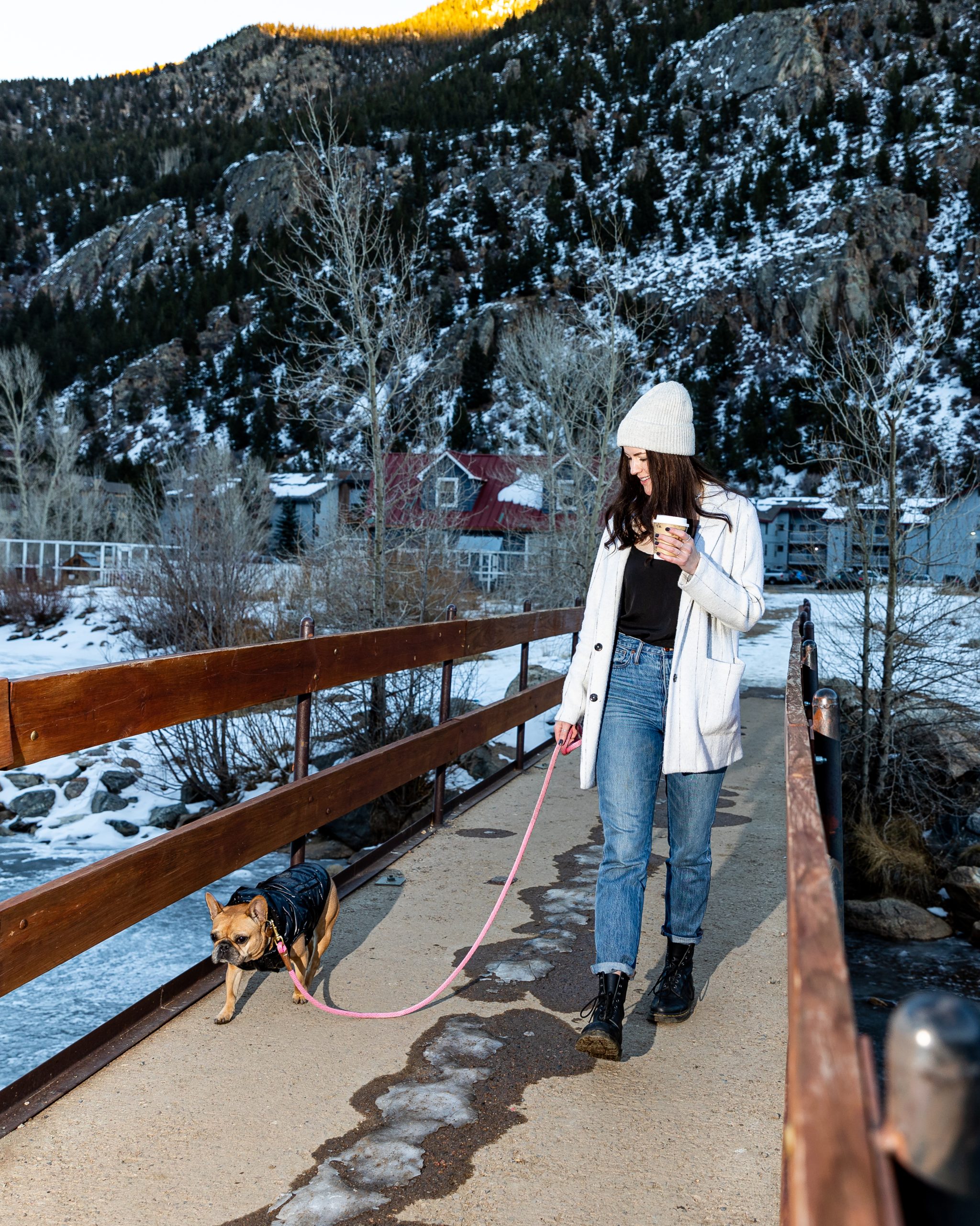 a woman walking her dog on a bridge at The Bighorn Crossing