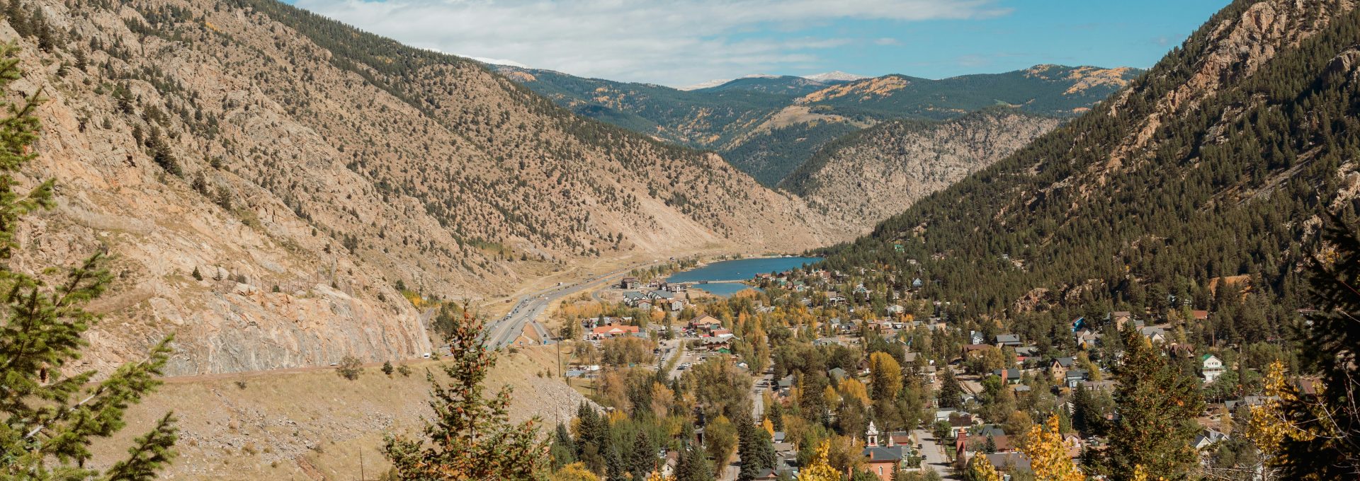 a scenic view of a town surrounded by mountains